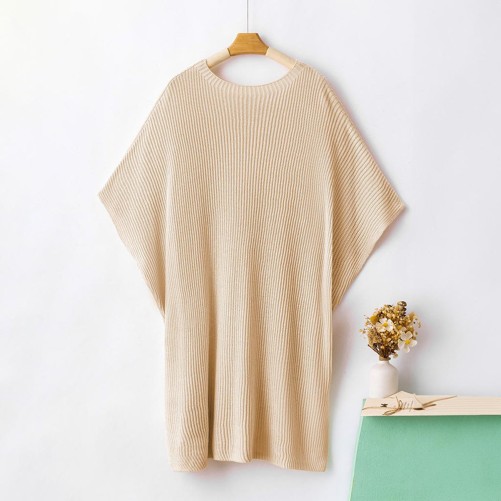 Beige ribbed knit top on a hanger showing the relaxed fit and side slits