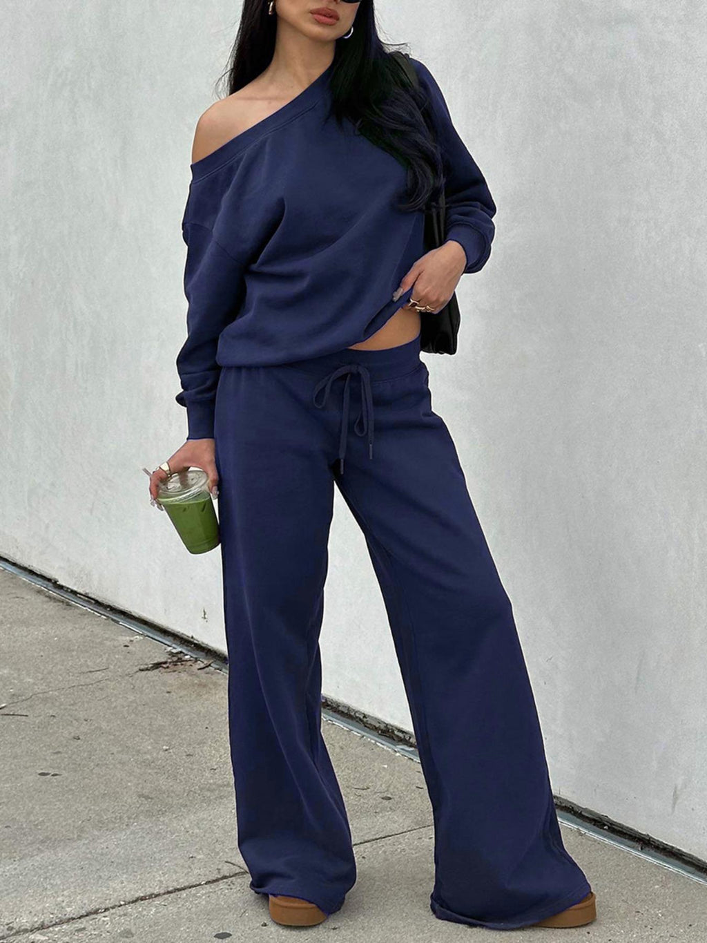 Woman in the navy blue off-shoulder lounge set with wide-leg pants