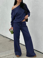 Woman in the navy blue off-shoulder lounge set with wide-leg pants
