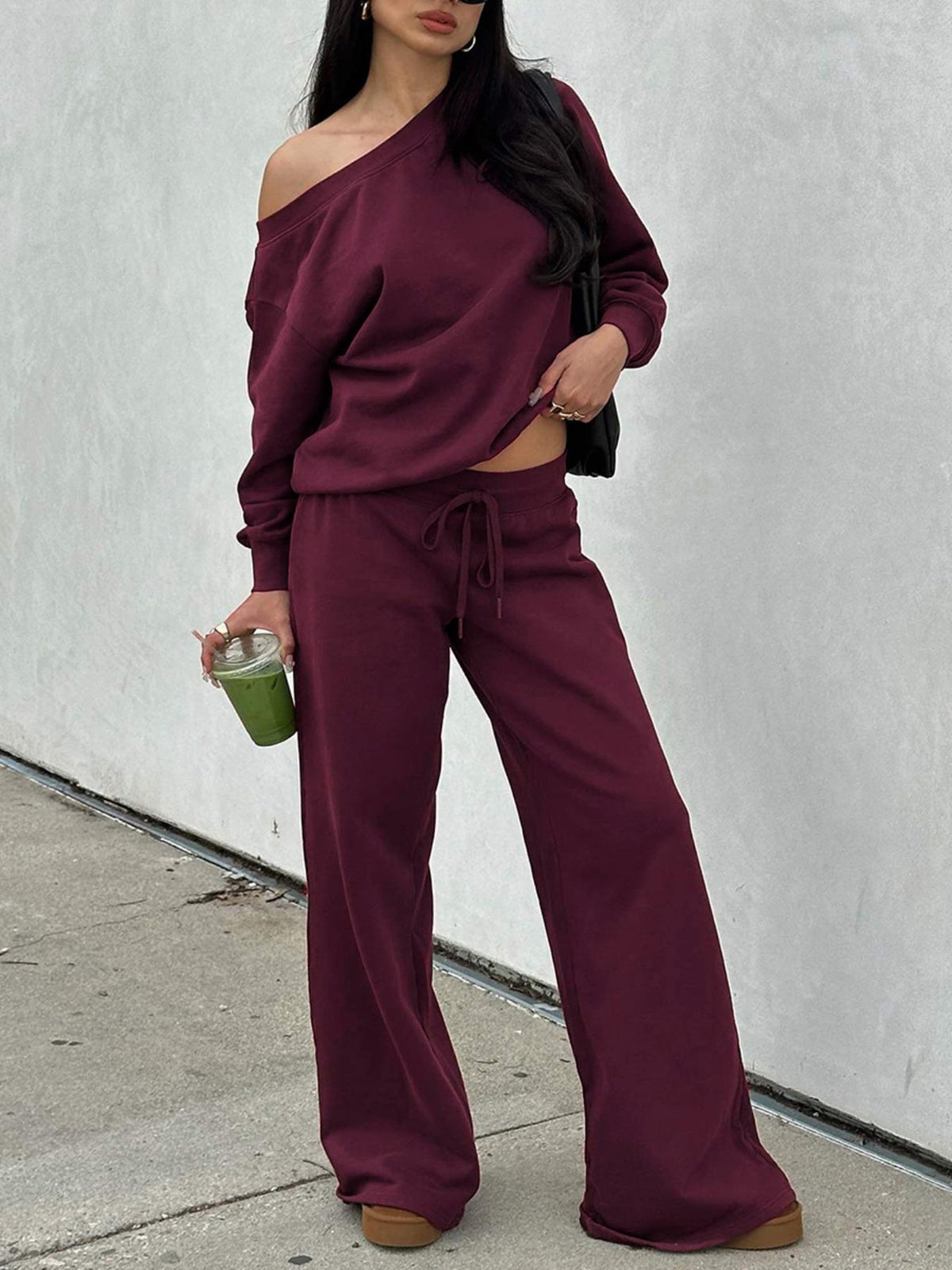 Woman in the burgundy off-shoulder lounge set with wide-leg pants
