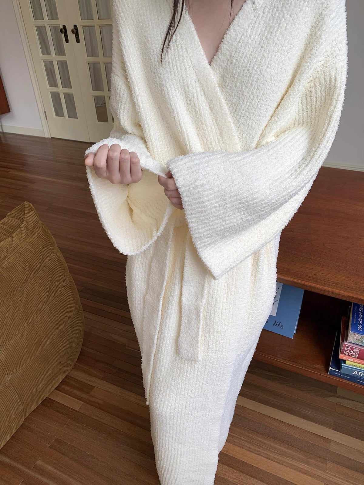 Close-up of the cream robe sleeve cuff and soft plush texture