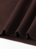 Close-up of the soft fabric drape on the wide-leg pant hem