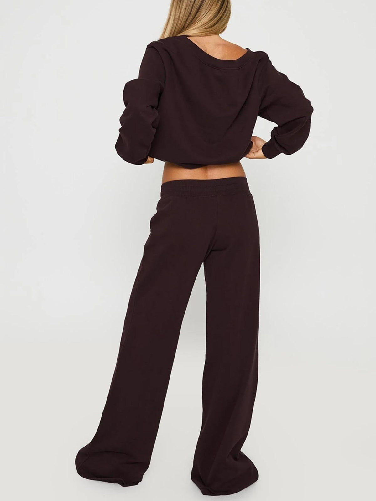 Back view of the coffee brown off-shoulder sweatshirt and wide-leg drawstring pants