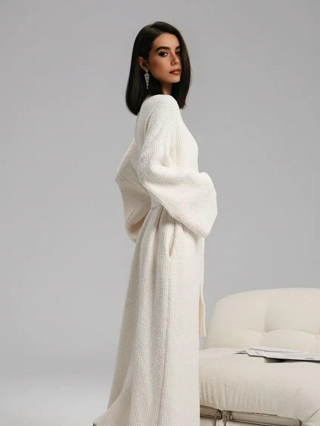 Side view of the cream long plush robe showing its full length