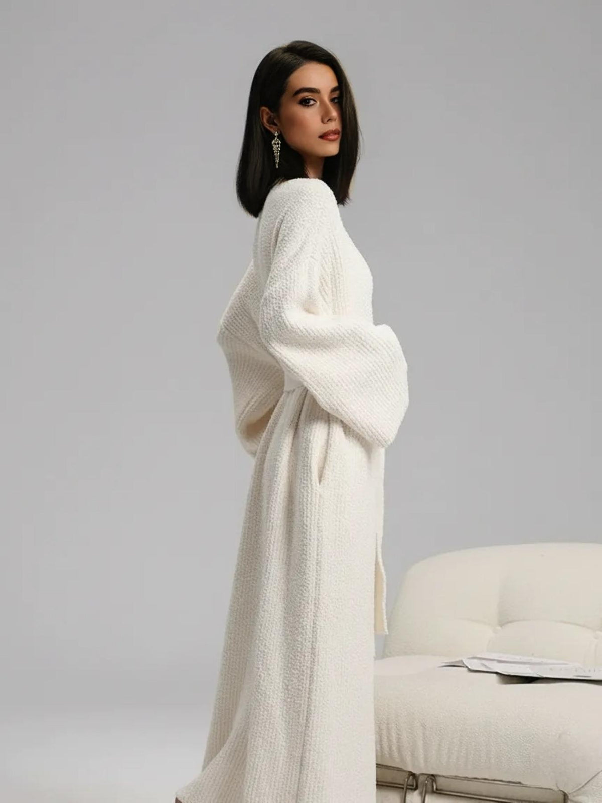 Side view of the cream long plush robe showing its full length