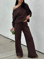 Woman wearing the coffee brown off-shoulder lounge set with wide-leg pants, front view