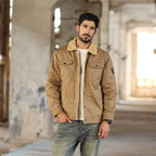 Man wearing the khaki sherpa trucker jacket over a white tee and jeans