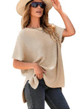 Woman in a beige oversized puff short sleeve knit top with jeans, white background